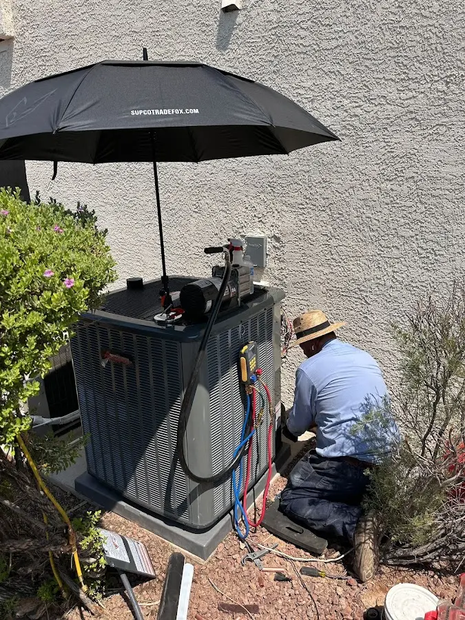 HVAC technician performing outdoor AC maintenance in West Milford